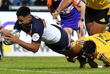 Irae Simone dives over the tryline with the ball while being tackled