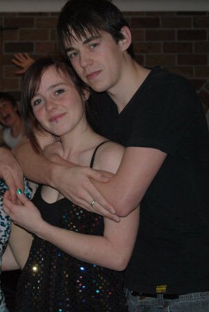 Photo of an 18 year old Rachele and a Nick at a party posing and smiling for the camera.