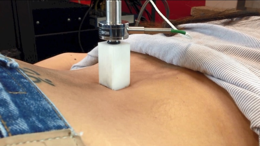 A medical instrument is used to examine a patient's back