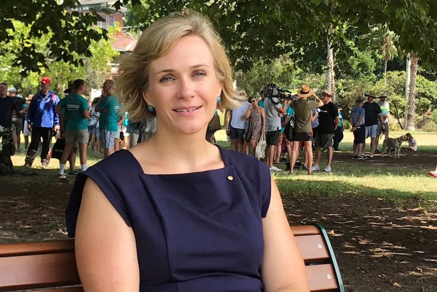 A woman sits on a park bench