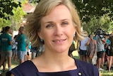 A woman sits on a park bench