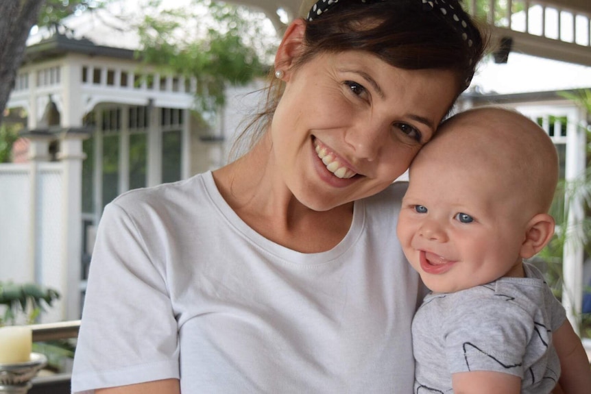 Young woman Jemma Manning holds baby Max.