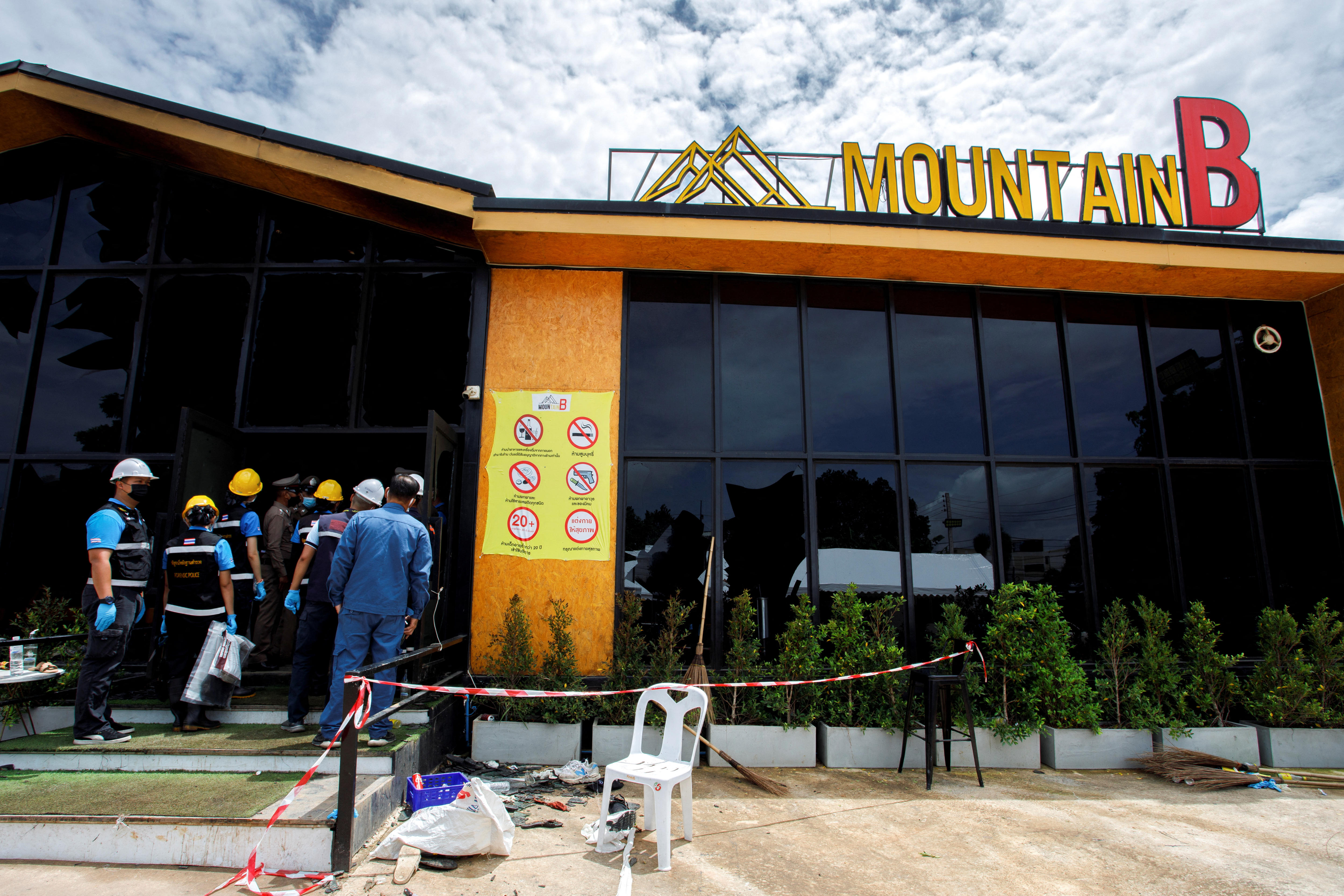 Forensic workers entering aThailand nightclub after a fire broke out. 