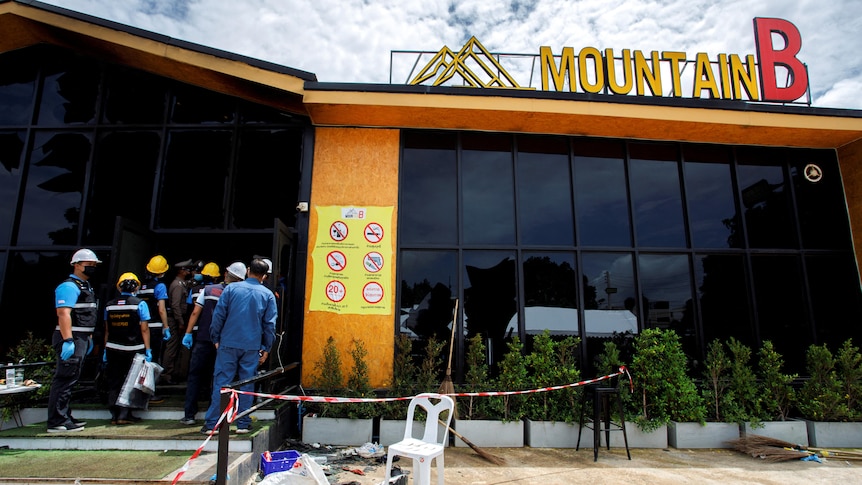 Forensic workers entering aThailand nightclub after a fire broke out. 