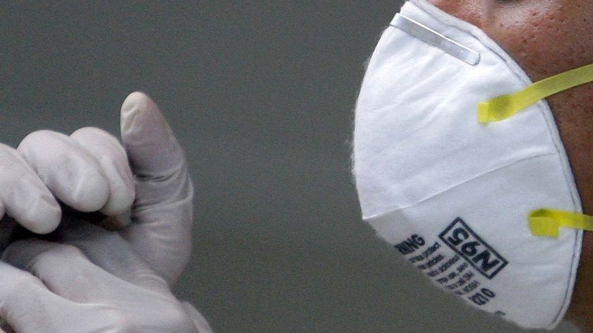 A security guard works near a quarantine area where a man is held for having swine flu