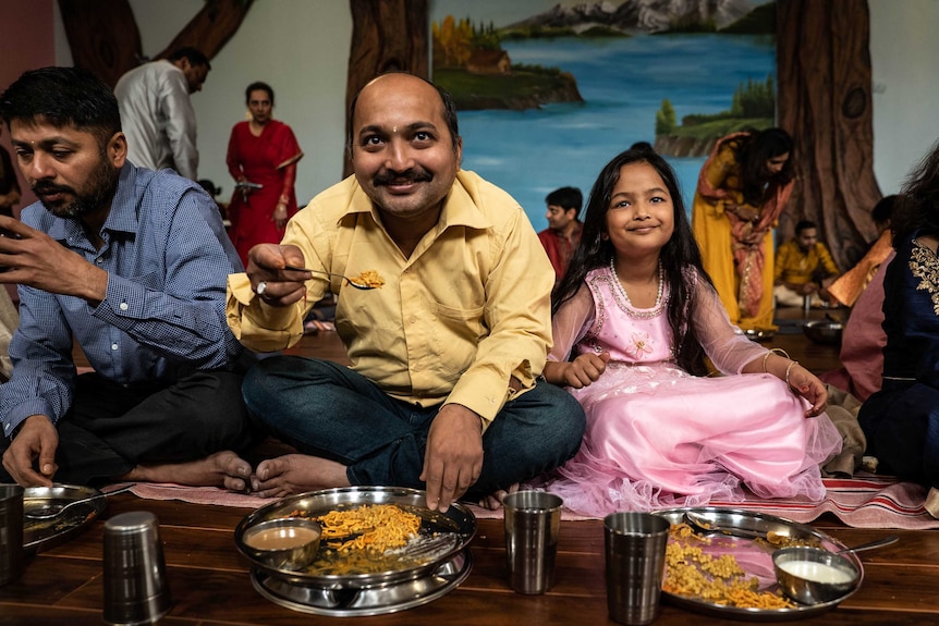 Jain father and daughter eating breakfast.