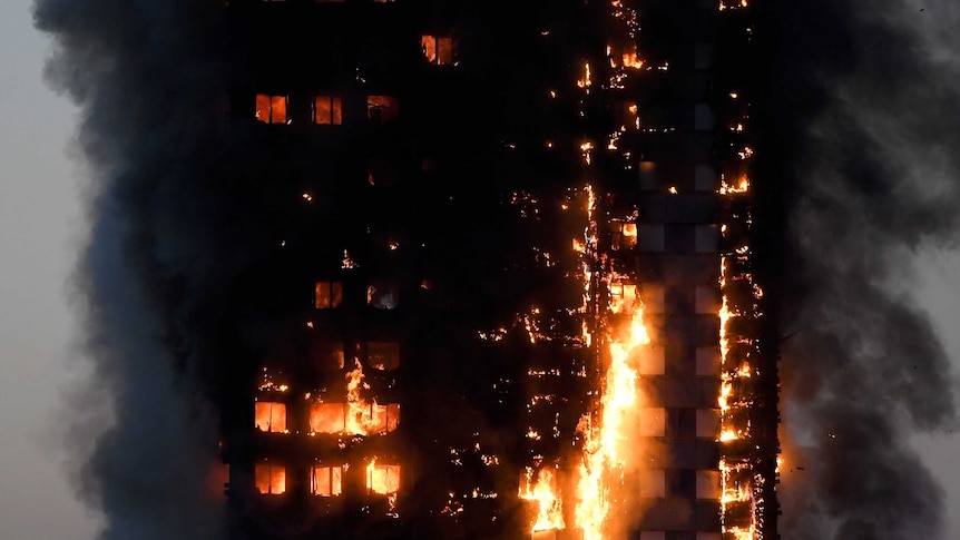 Flames and smoke billow from a burnt-out apartment building in London.