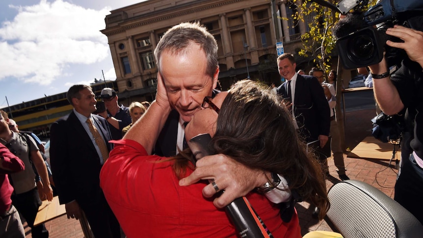 A woman kisses Bill Shorten in Adelaide