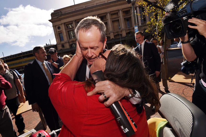 A woman kisses Bill Shorten in Adelaide