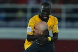 Awer Mabil celebrates goal against Syria with Graham Arnold