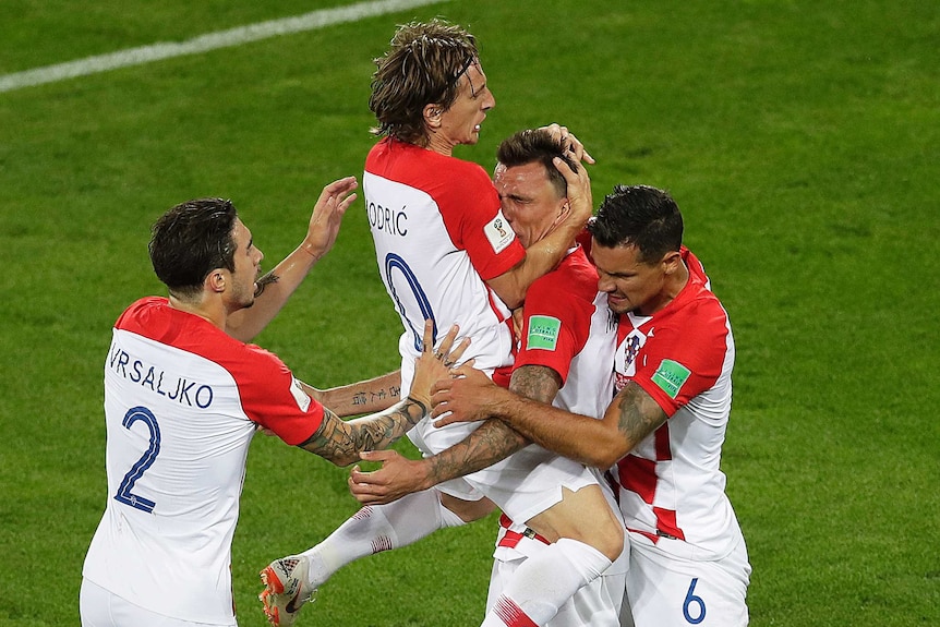Croatia players jump up and down to celebrate goal