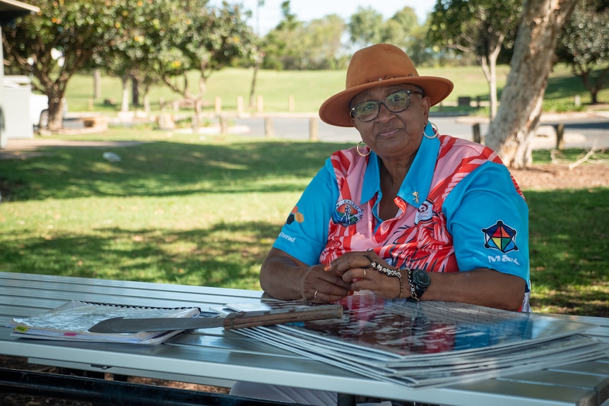 Marion Healy sits at picnic table in Mackay, November 2021.