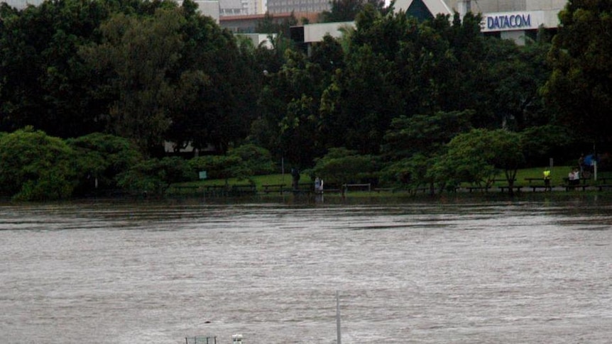 Worse than 1974 ... A pontoon floats down the Brisbane River.