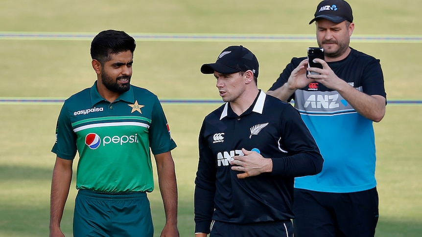 New Zealand and Pakistan skippers walk together at a cricket stadium in Rawalpindi, Pakistan, September 2021.