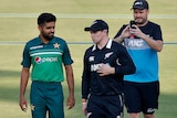 New Zealand and Pakistan skippers walk together at a cricket stadium in Rawalpindi, Pakistan, September 2021.
