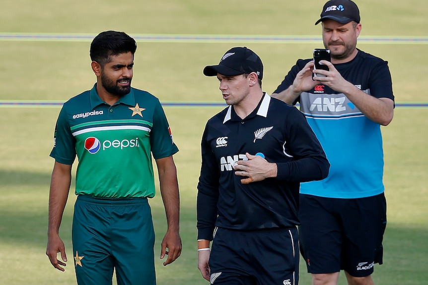 New Zealand and Pakistan skippers walk together at a cricket stadium in Rawalpindi, Pakistan, September 2021.