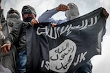 Demonstrators hold up the flag of the Islamic State group during a rally in Srinagar, India.