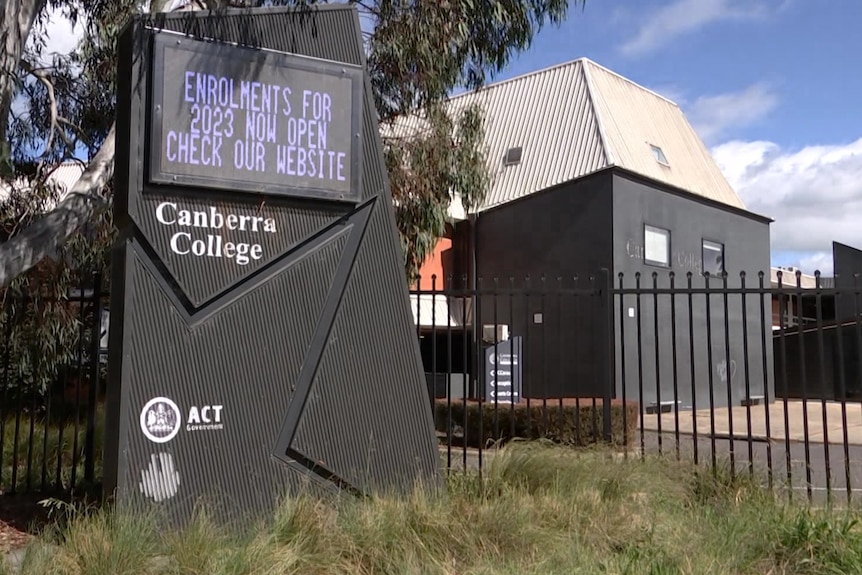 A sign outside a school reads 'Canberra College' and 'Enrolments for 2023 now open'.