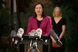 Queensland Premier Annastacia Palaszczuk, with Dr Jeannette Young behind her, speaks at a media conference