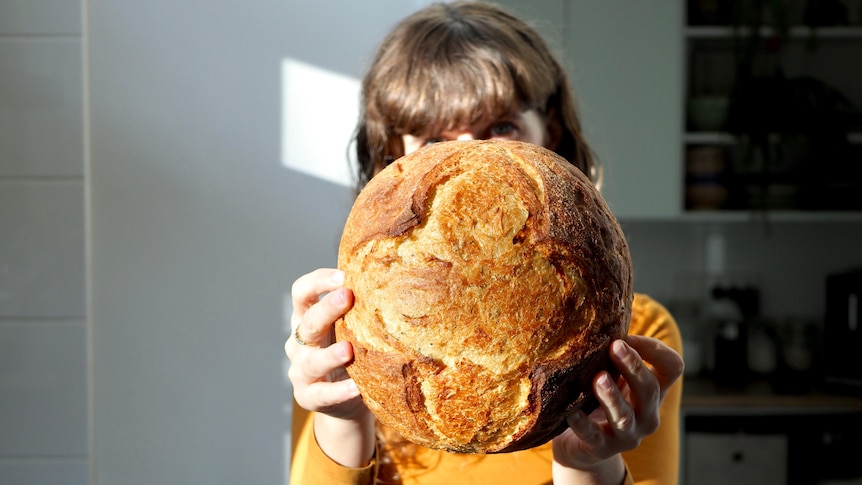 Mary Grace Quigley holds a loaf of potato bread. 