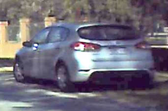 A grainy screenshot of a silver hatchback.