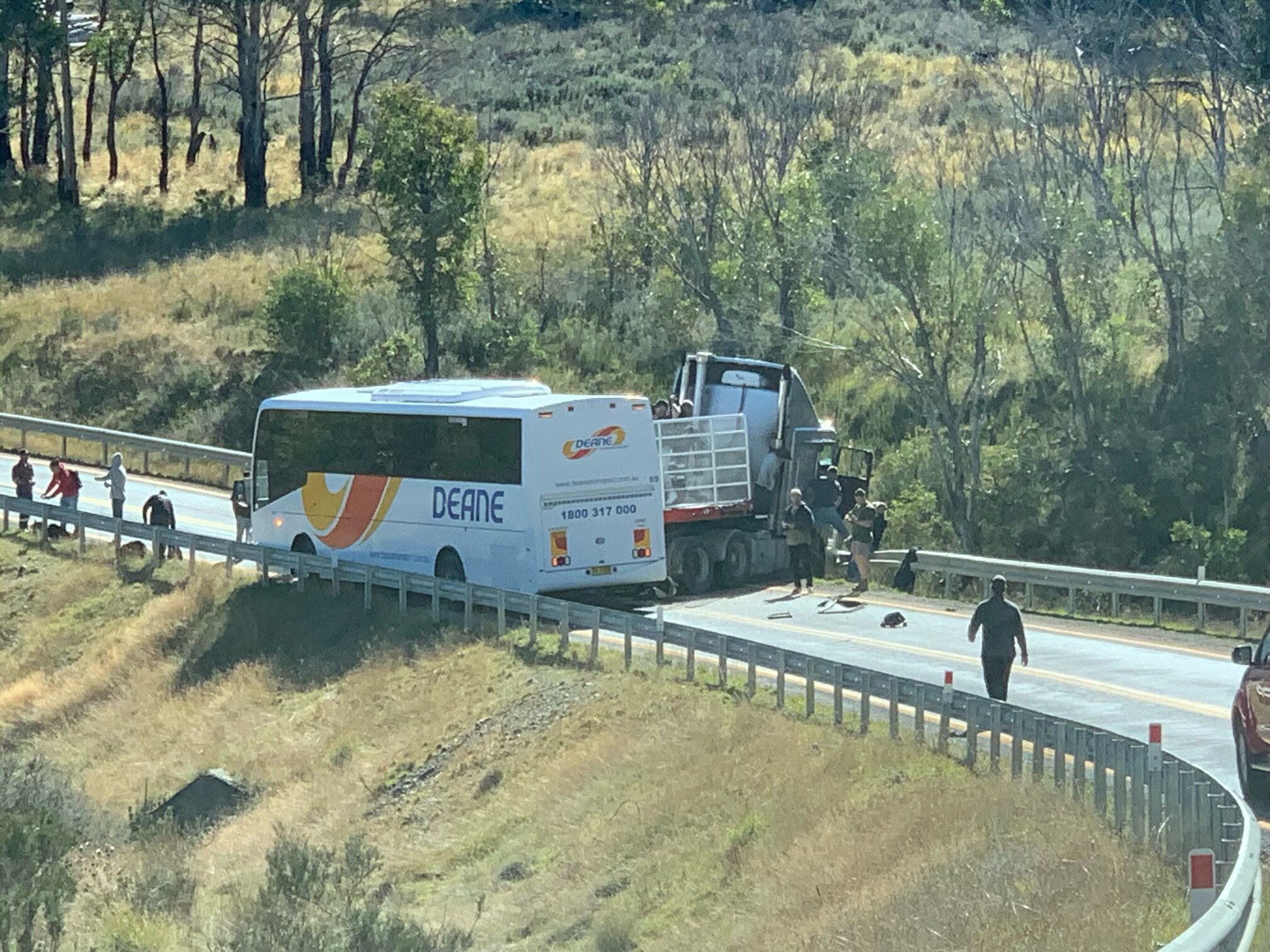A bus and a truck at a stand still which appear to have crashed in to one another. 