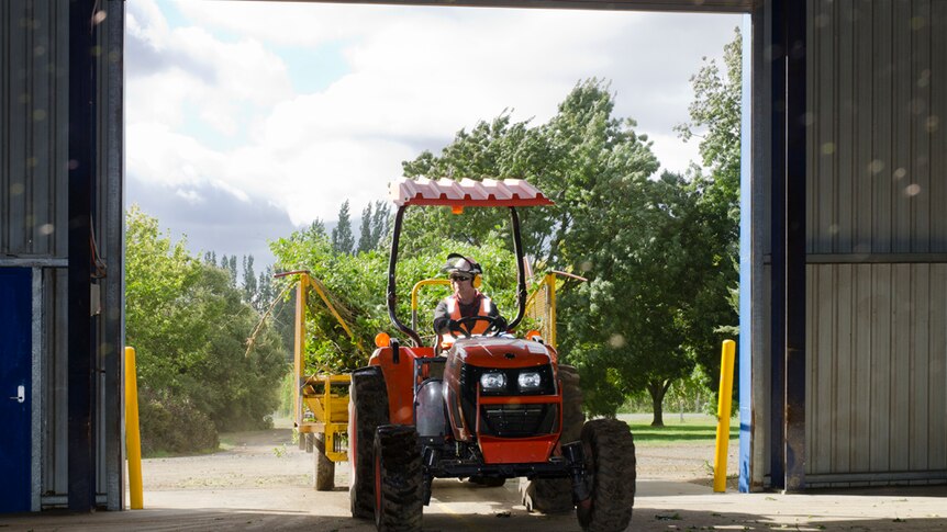 Tractor pulls into a shed