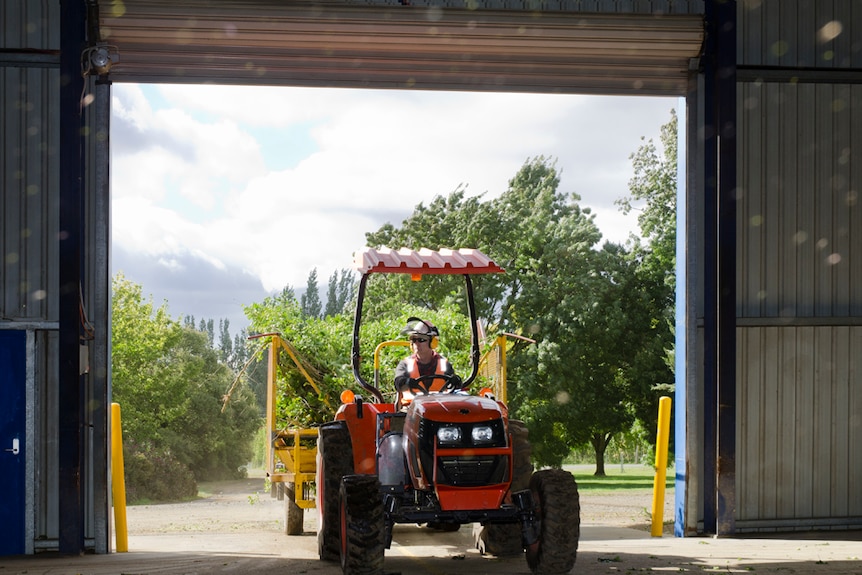 Tractor pulls into a shed