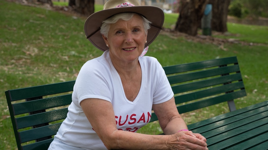 Susan Gascoine seated at a park bench.