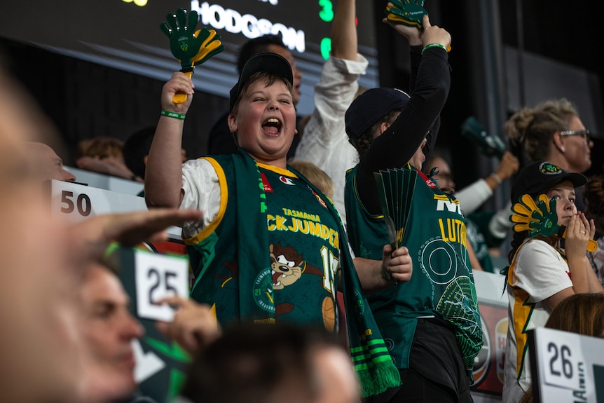 Young fans celebrate during Tasmania JackJumpers basketball game.