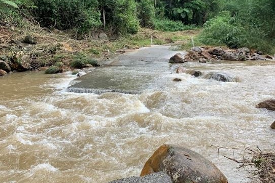 A section of road missing after being swept away.