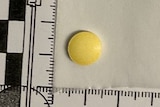 A small yellow tablet next to a ruler.