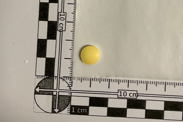 A small yellow tablet next to a ruler.