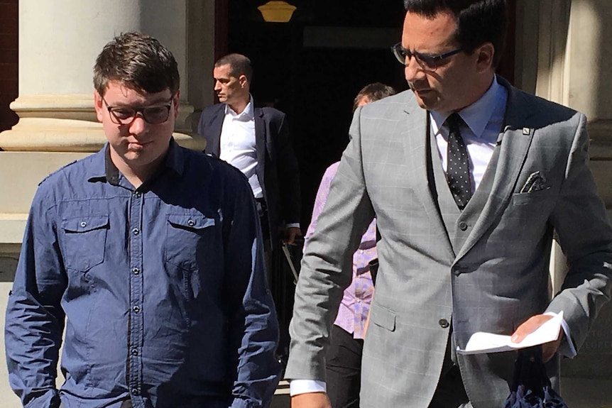 A man in a blue shirt and a lawyer in a grey suit outside the WA Supreme Court.