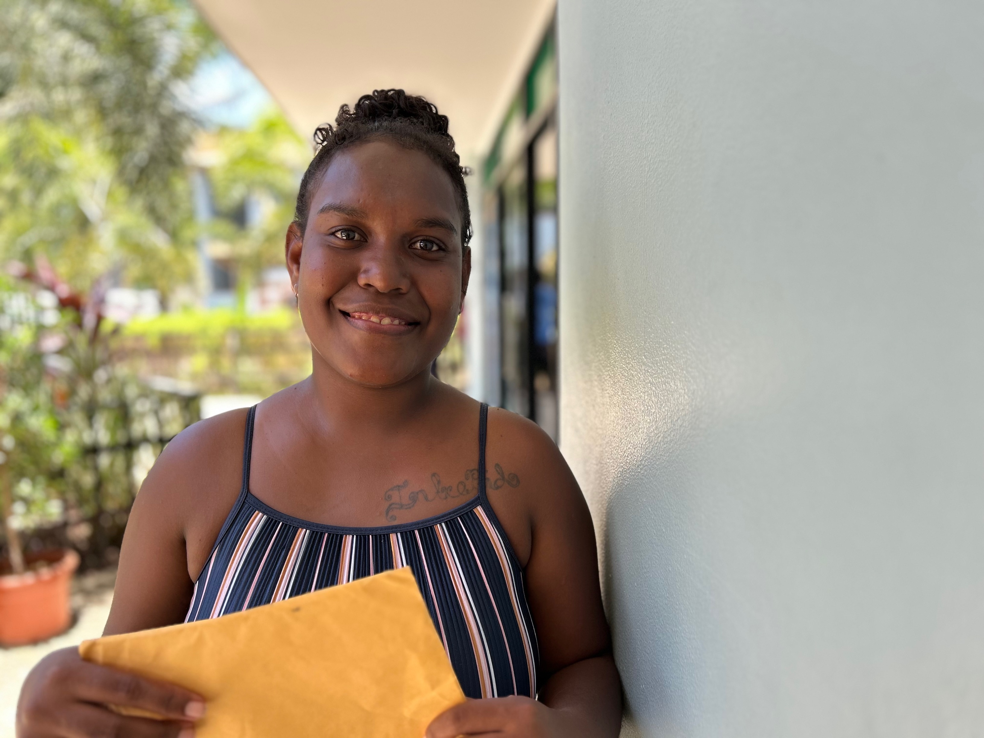 A Solomon Islaner woman holding a manila folder