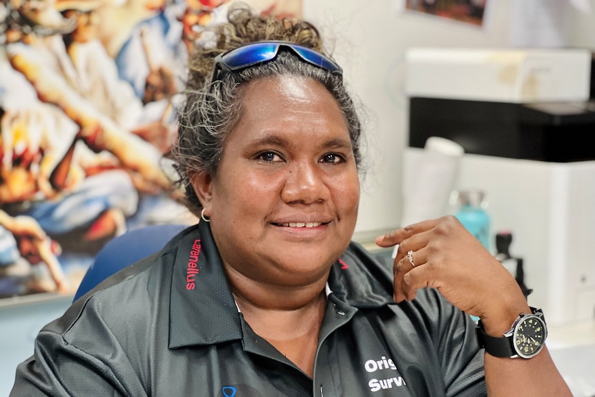 A woman wearing a black shirt, smiling.