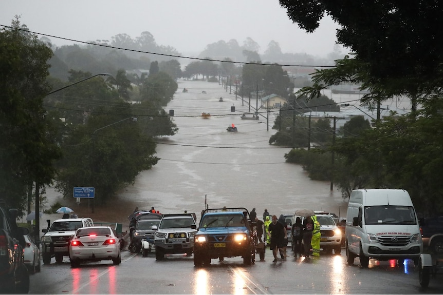 Boats rescue people on flooded roads in Lismore