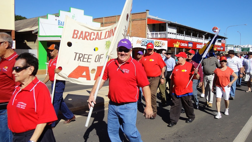 Marchers with 'Tree of Knowledge' banner lead the Labour Day parade in Barcaldine in central-west Queensland on May 7, 2012.