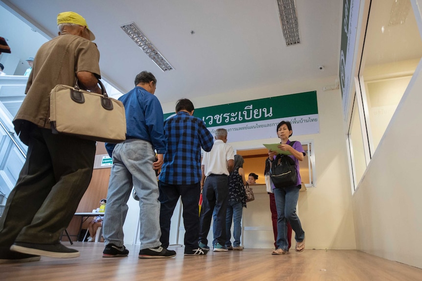 Elderly people line-up at Thailand's first full-time clinic prescribing cannabis oil.