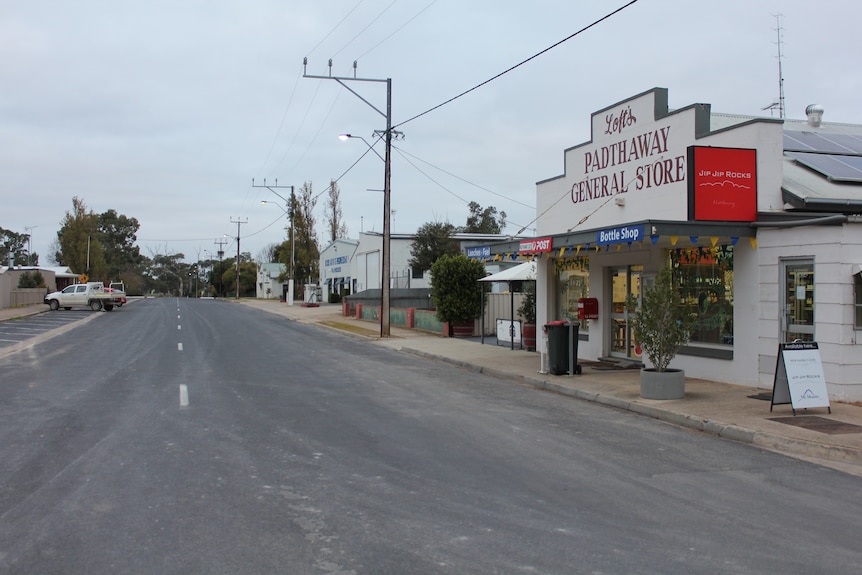 A street lined by the Padthaway General Store and a mechanics is empty but for a parked ute