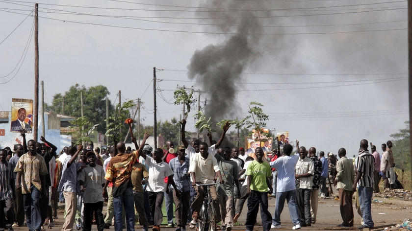 Demonstrators march along a road in the western Kenyan town of Kisumu