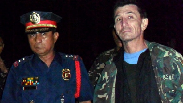 Rodwell is escorted by Philippine police shortly after his release from Islamic militant kidnappers