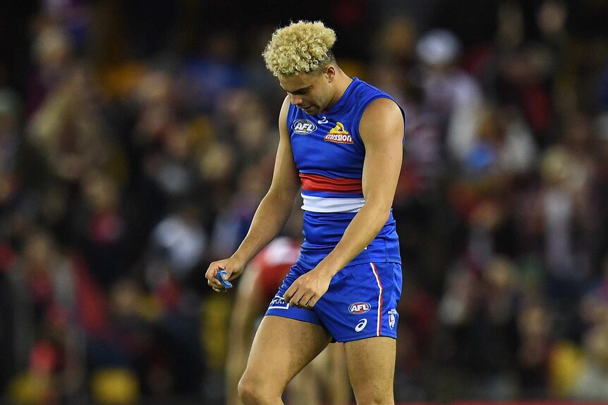 Jason Johannisen of the Western Bulldogs looks dejected after his team's loss to the Melbourne Demons.
