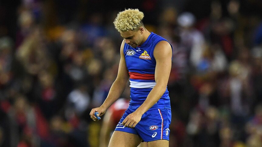 Jason Johannisen of the Western Bulldogs looks dejected after his team's loss to the Melbourne Demons.