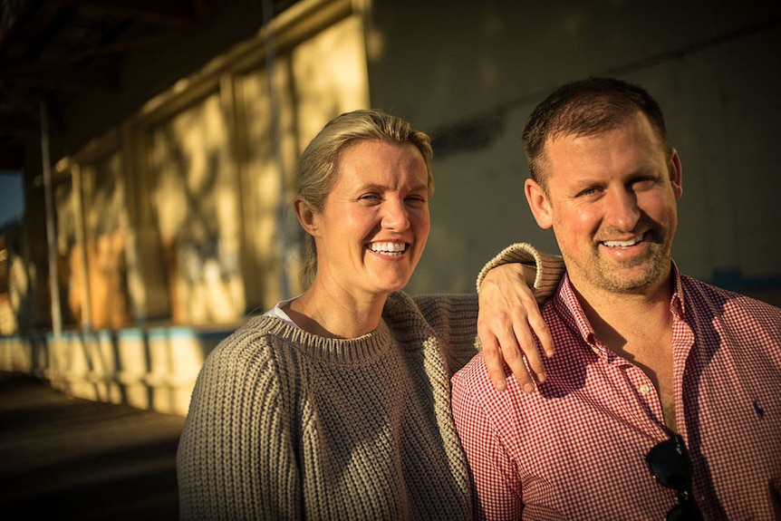 Nadia Watson and Richard Magney standing in the afternoon sun outside the former rail freight terminal in Cowra