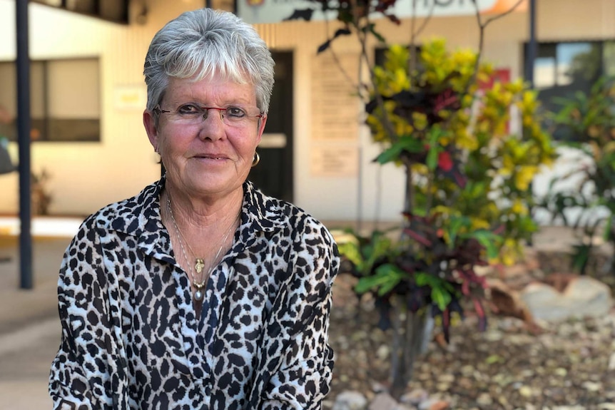 Kimberley Aboriginal Medical Service CEO Vicki O'Donnell sits outdoors posing for a photo wearing a black and white top.