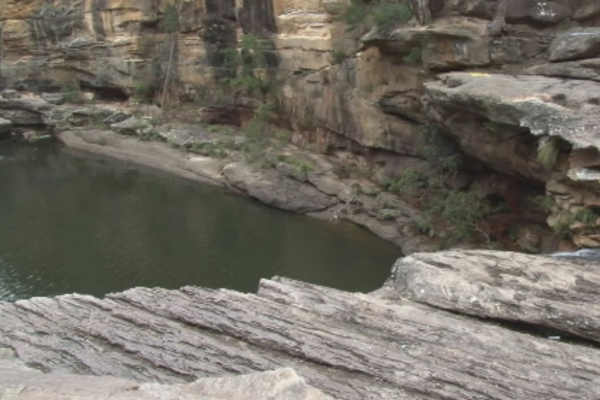 Rock pool surrounded by cliffs.