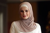 Woman wearing a pink and white hijab 