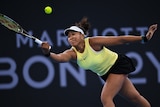 Naomi Osaka hitting a tennis ball