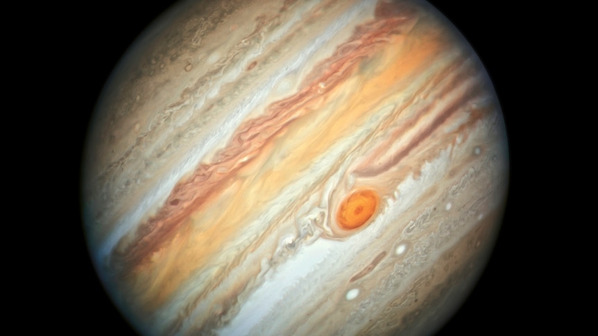 A picture of Jupiter with the red spot near centre and bands on an angle.